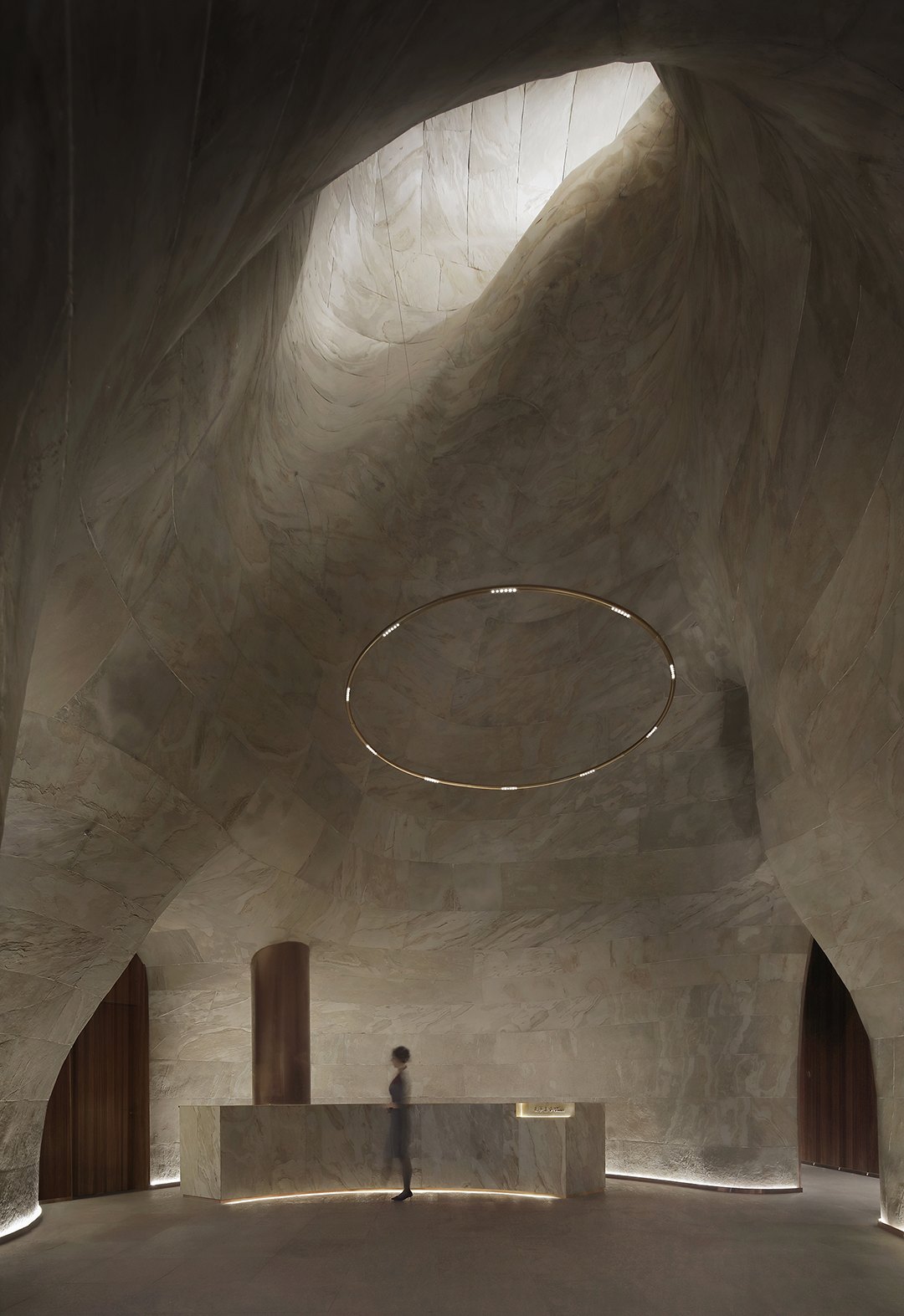 Stone surface — curved cave-form lobby